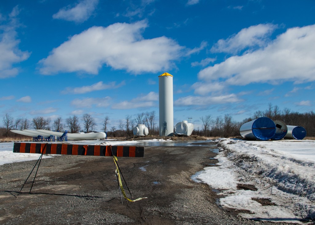 parts of an industrial wind turbine lying in a field